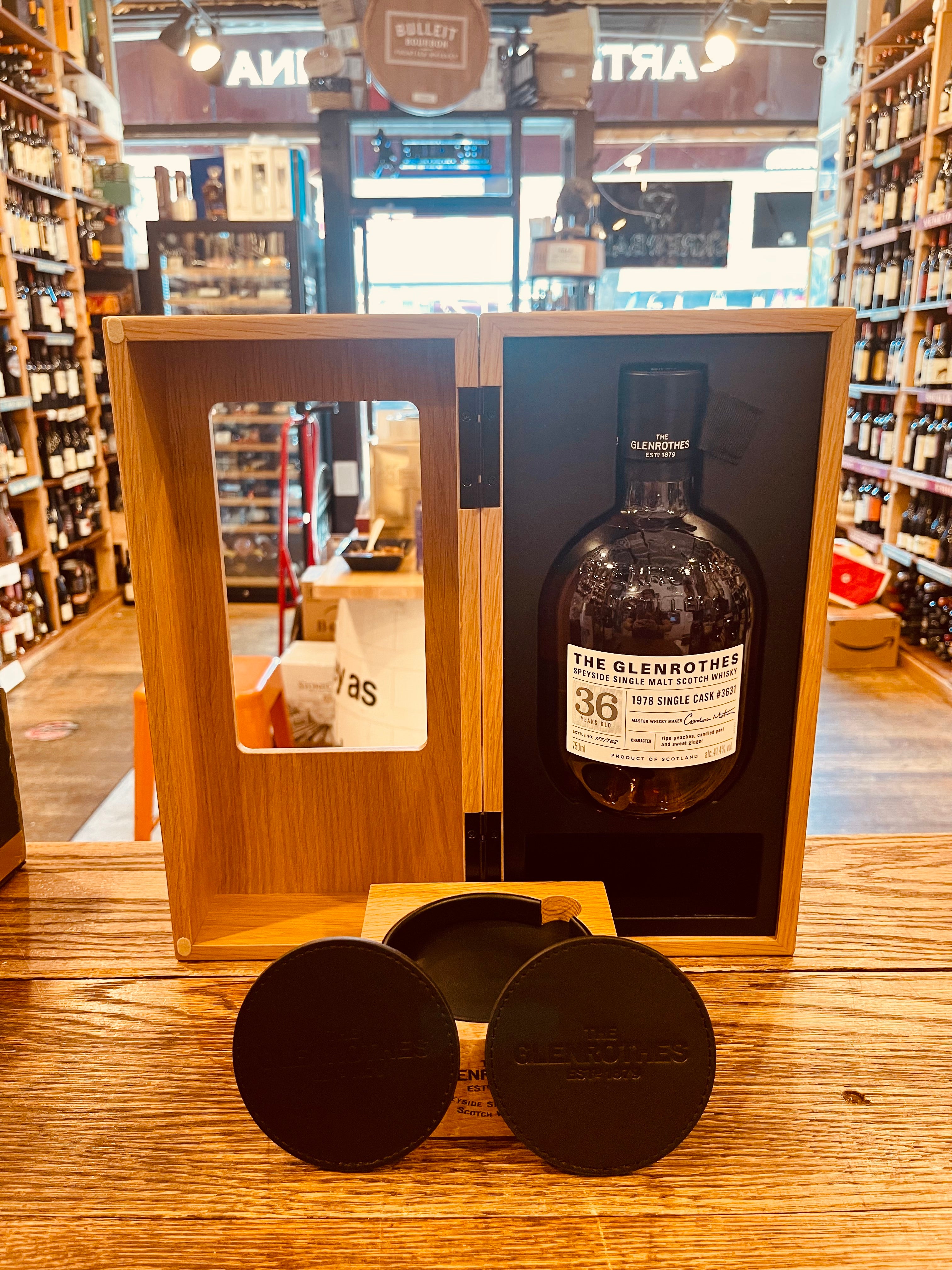 Glenrothes Platinum Single Cask 36Yr 1978 750mL NFT a wooden box with a dark small squat bottle displayed inside with a white label and black top