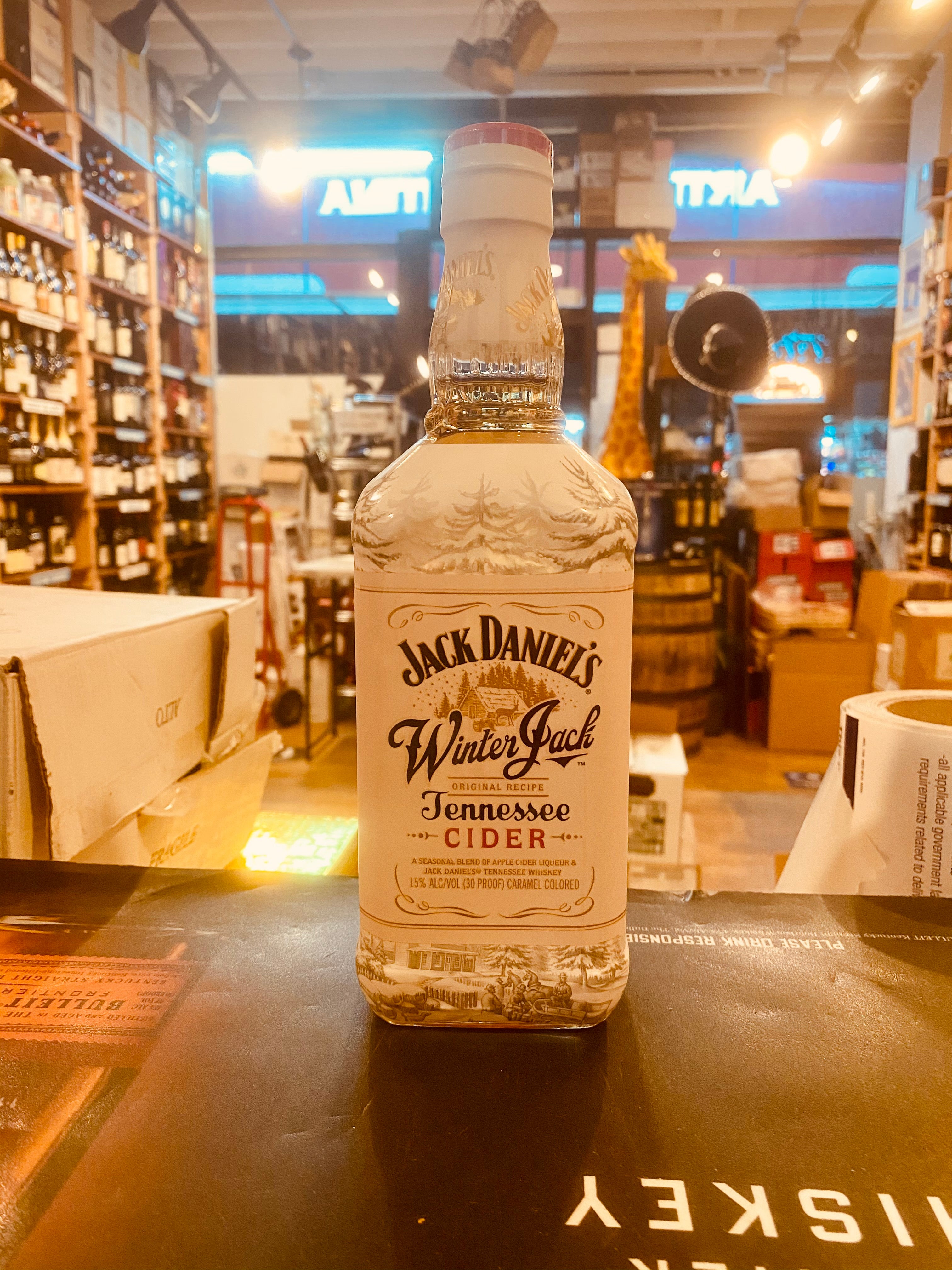Jack Daniels Winter Jack Tennessee Cider 750mL a tall squared white glass bottle with black lettering
