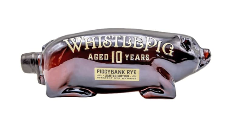 Whistle Pig Piggybank Rye 1L a clear glass bottle that is shaped like a pig with white lettering